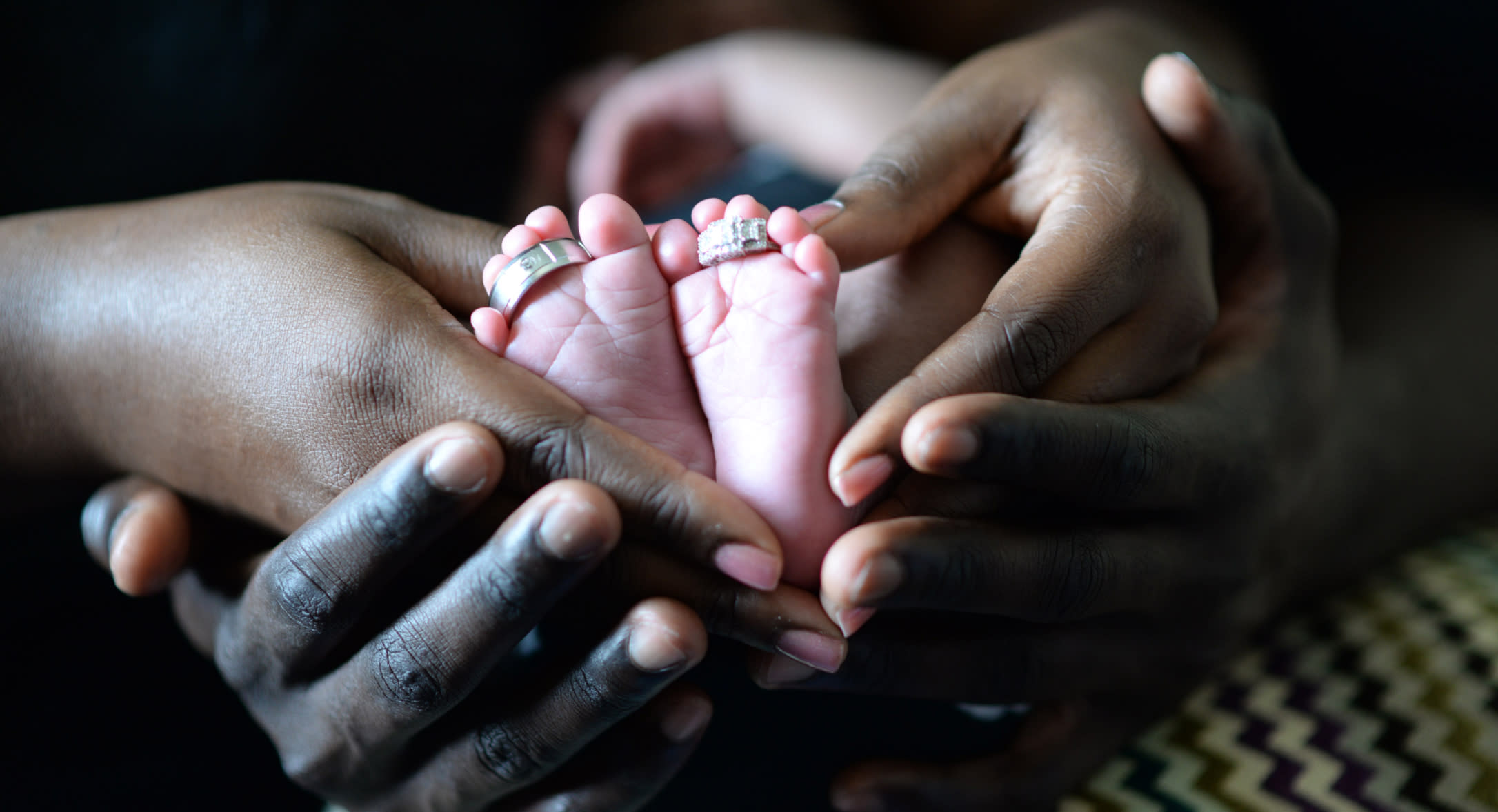 Person touching baby’s feet